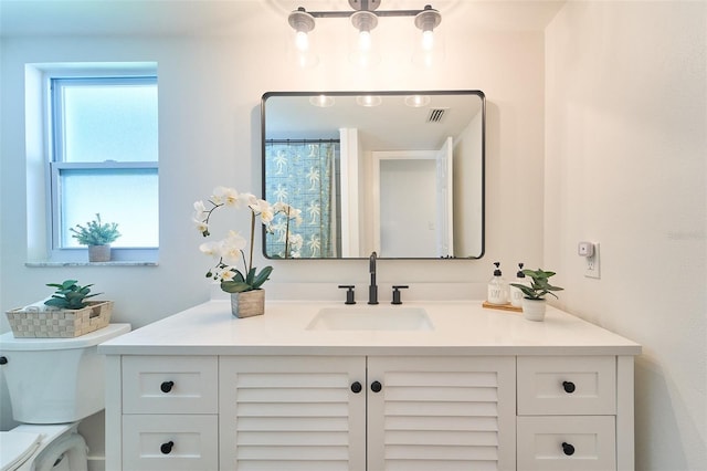 full bath with visible vents, toilet, and vanity