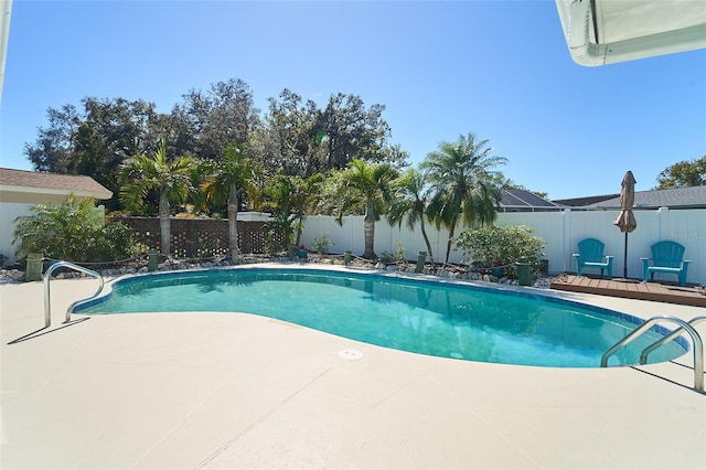 view of pool with a patio, a fenced backyard, a fenced in pool, and a wooden deck