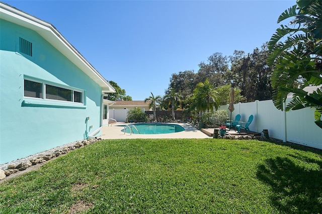 view of yard with a fenced in pool, a fenced backyard, and a patio area