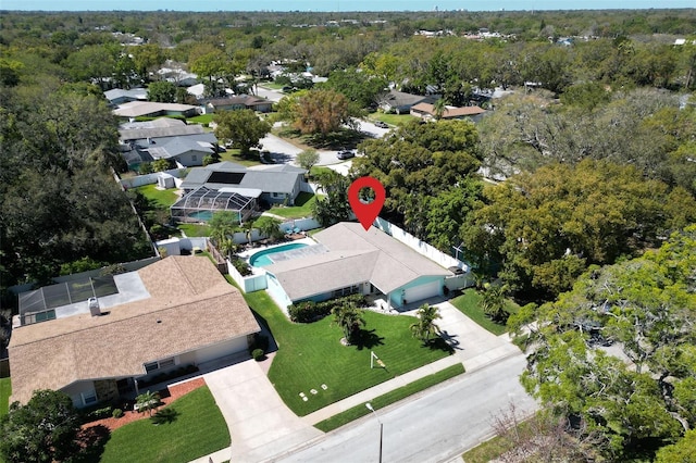 drone / aerial view with a residential view and a view of trees