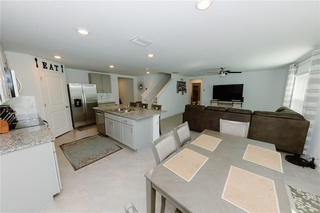 dining space featuring visible vents, recessed lighting, stairs, and a ceiling fan