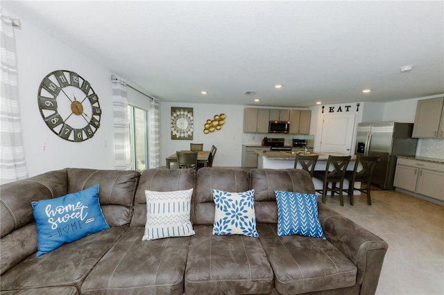 living area with light tile patterned floors and recessed lighting