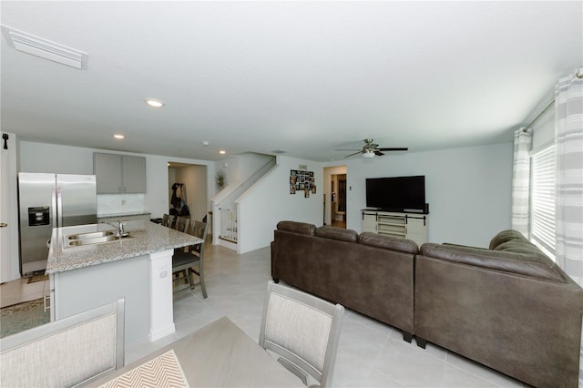 living area with visible vents, recessed lighting, stairway, and ceiling fan