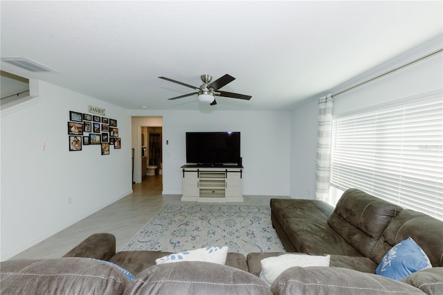 living area with visible vents and ceiling fan