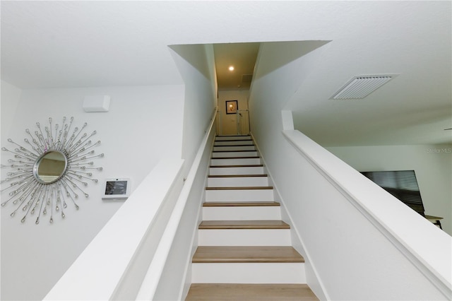 staircase featuring visible vents