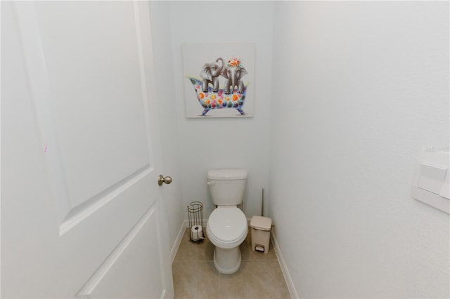 bathroom with tile patterned floors, toilet, and baseboards