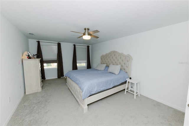 bedroom with a ceiling fan, carpet, visible vents, and baseboards