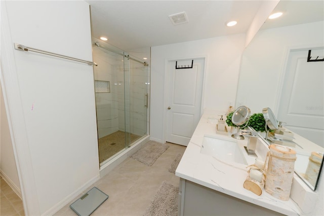 bathroom featuring a marble finish shower, visible vents, double vanity, recessed lighting, and a sink