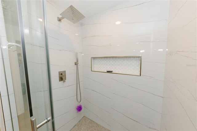 bathroom with a marble finish shower and lofted ceiling