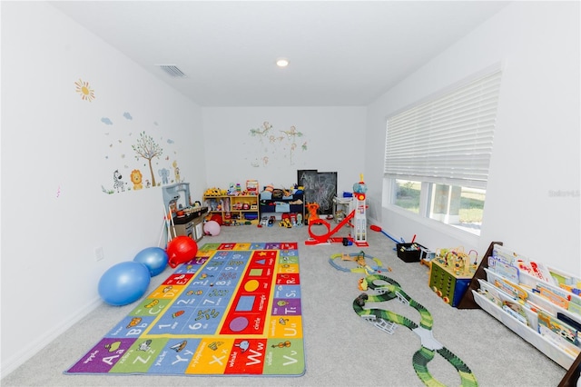 recreation room with visible vents and carpet flooring