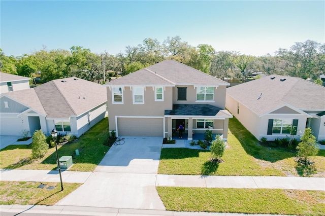 traditional home featuring a front lawn, an attached garage, concrete driveway, and stucco siding