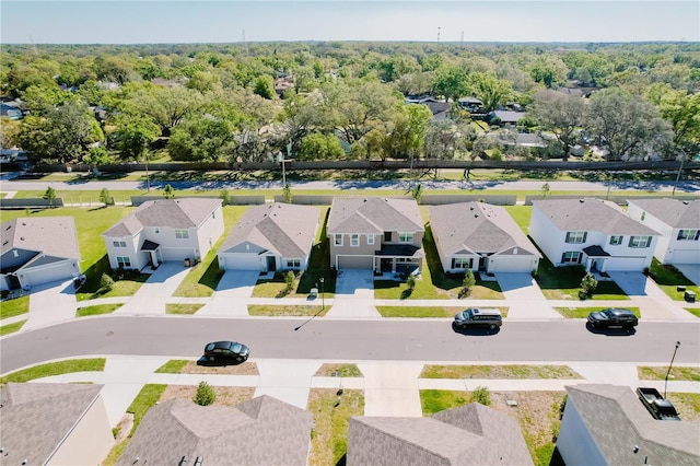 bird's eye view featuring a forest view and a residential view