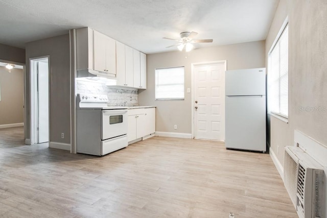 kitchen with white appliances, a ceiling fan, light wood-type flooring, white cabinetry, and tasteful backsplash