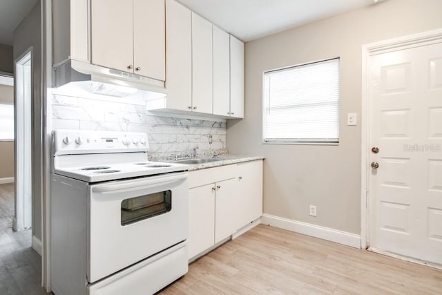 kitchen with light wood-style flooring, white electric range, tasteful backsplash, white cabinetry, and light countertops