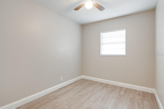 empty room with baseboards, light wood-style floors, and a ceiling fan