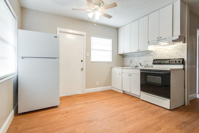 kitchen featuring white appliances, decorative backsplash, under cabinet range hood, white cabinetry, and light wood-type flooring