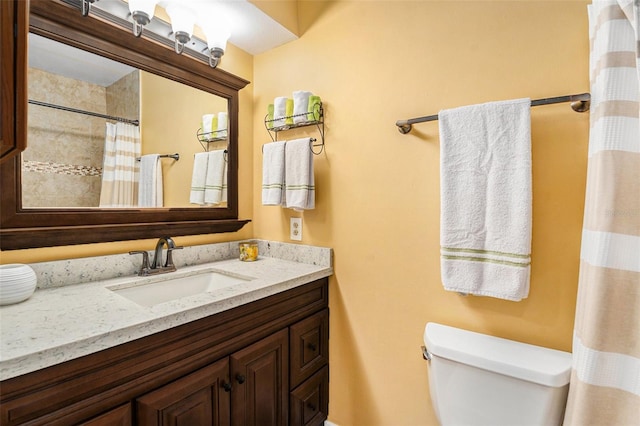 bathroom with toilet, curtained shower, and vanity