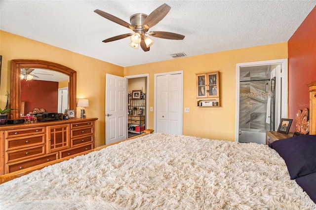 bedroom with visible vents, ensuite bathroom, a closet, a textured ceiling, and a ceiling fan