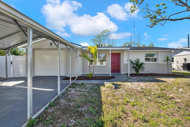 ranch-style house with central air condition unit, driveway, an attached garage, and fence