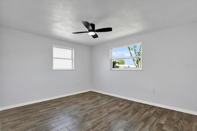 unfurnished room featuring a ceiling fan, wood finished floors, and baseboards