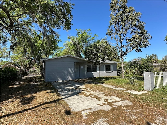 view of front of home with driveway and fence