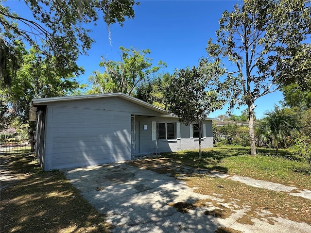 view of front of home with aphalt driveway and concrete block siding