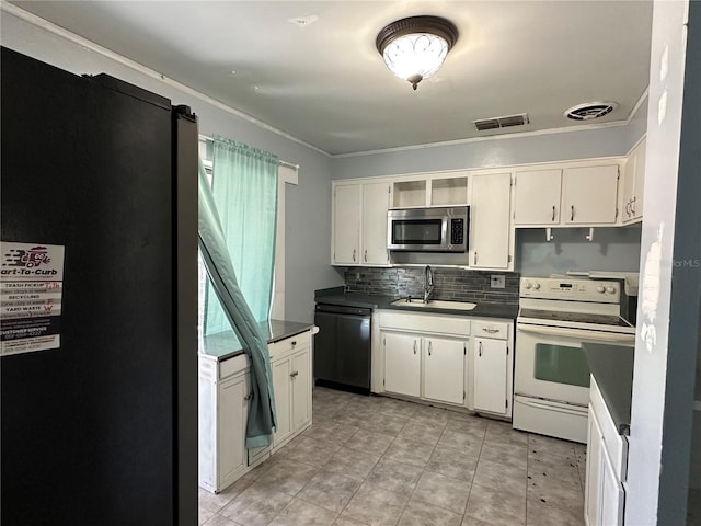 kitchen with dark countertops, visible vents, appliances with stainless steel finishes, and a sink