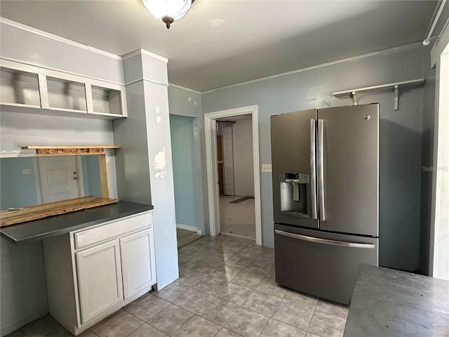 kitchen featuring open shelves, dark countertops, white cabinets, and stainless steel fridge with ice dispenser