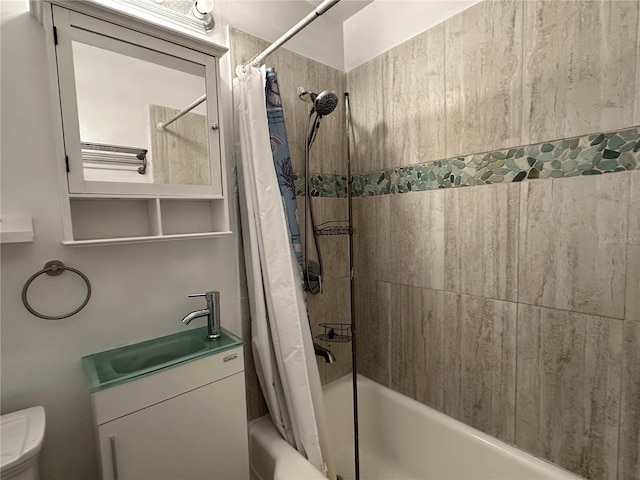 bathroom with vanity, shower / bath combination with curtain, and toilet