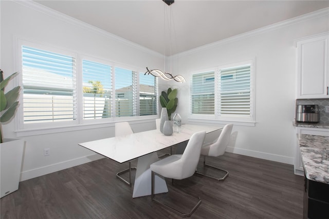 dining space featuring dark wood finished floors, crown molding, and baseboards