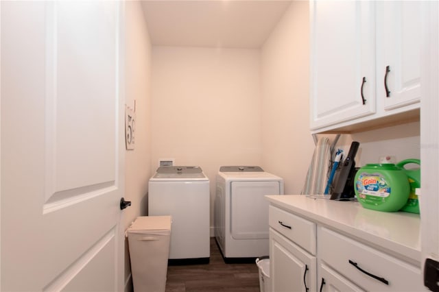 laundry room featuring dark wood-style flooring, cabinet space, and separate washer and dryer