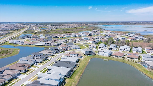 bird's eye view with a residential view and a water view