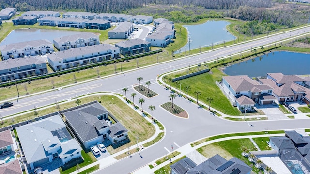 drone / aerial view featuring a residential view and a water view