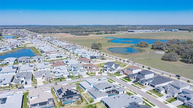 birds eye view of property featuring a water view and a residential view