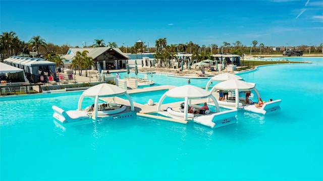 pool with a gazebo and a water play area