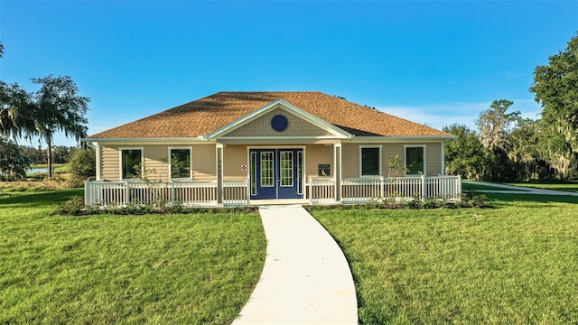 single story home with a front lawn, french doors, and covered porch