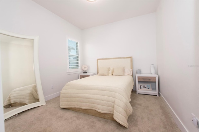 bedroom featuring carpet and baseboards