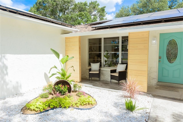 property entrance with covered porch and solar panels