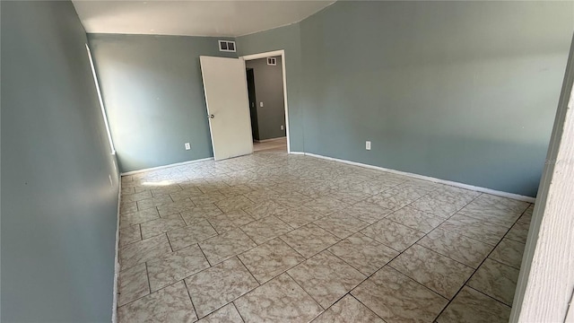 spare room with visible vents and baseboards