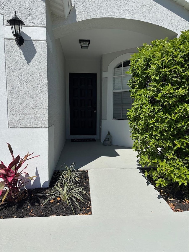 doorway to property with stucco siding