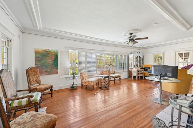 sitting room featuring ceiling fan, a healthy amount of sunlight, ornamental molding, and hardwood / wood-style flooring