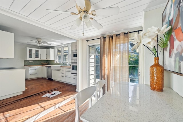 kitchen with white cabinetry, white oven, decorative backsplash, dishwasher, and ceiling fan