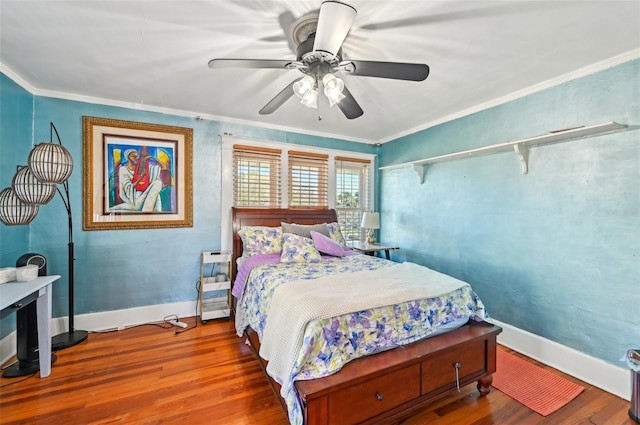 bedroom featuring ceiling fan, baseboards, wood finished floors, and ornamental molding