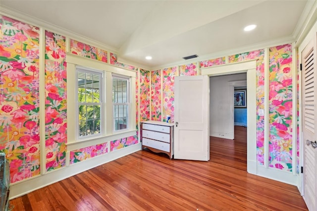 unfurnished room featuring visible vents, wood finished floors, recessed lighting, wallpapered walls, and baseboards