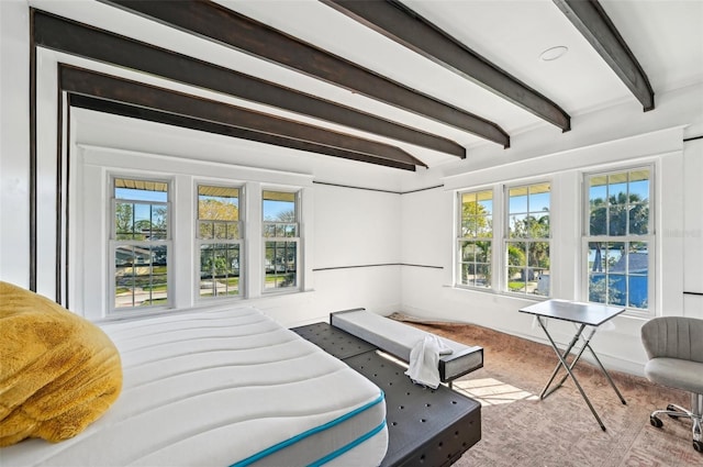 bedroom with beam ceiling and baseboards