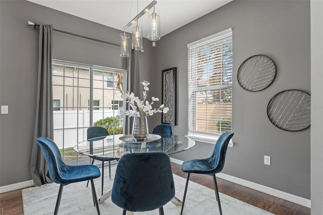 dining area with wood finished floors, baseboards, and a healthy amount of sunlight