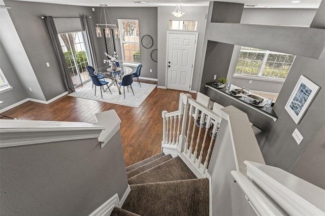 interior space featuring plenty of natural light, baseboards, and wood-type flooring