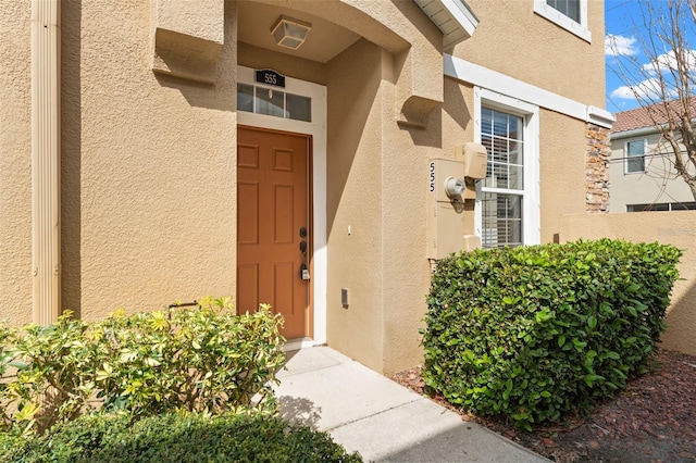 doorway to property with stucco siding