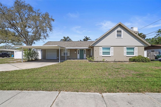 view of front of home featuring a carport, a garage, concrete driveway, and a front yard