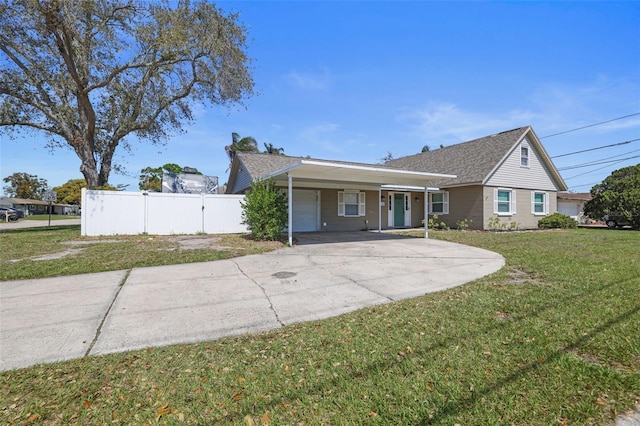 view of front of home with a front lawn, a carport, driveway, and fence